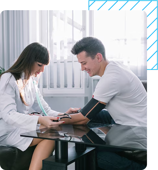 Two men are sitting on a bench with iv bags in their legs.