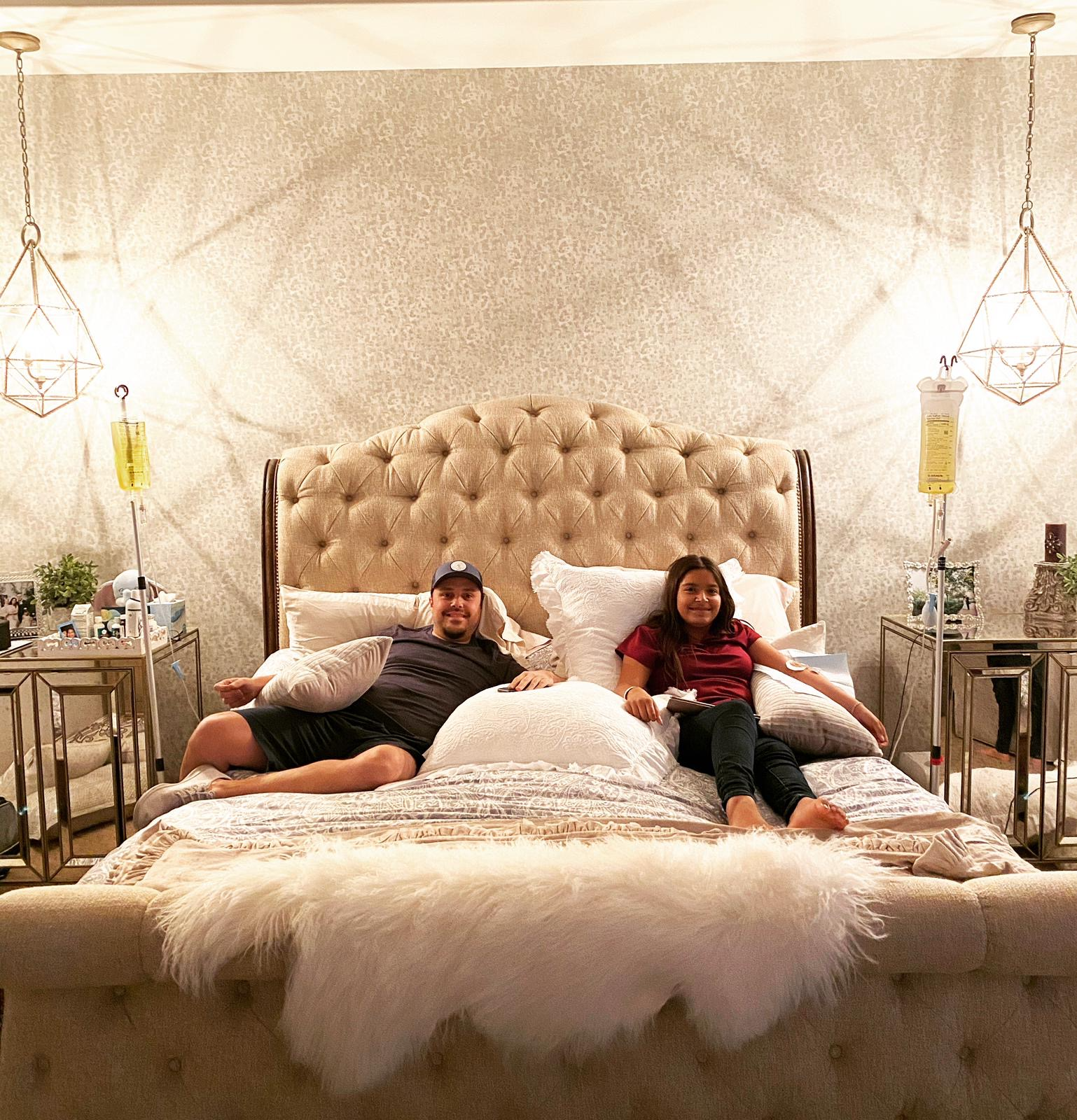 A man and a woman are laying on a bed.