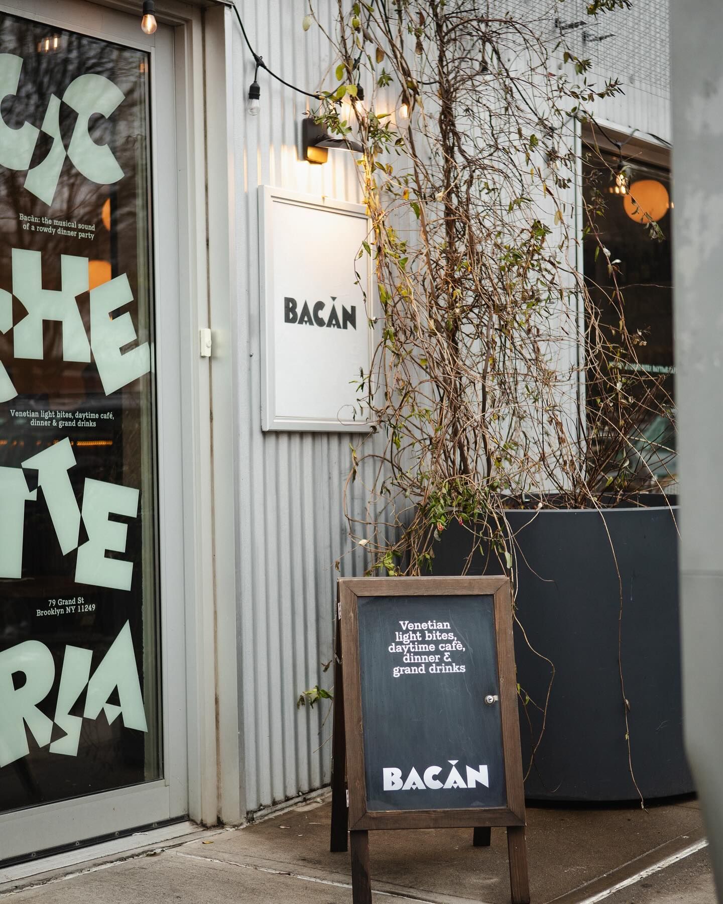 Front door banner. Restaurant and menu design, Bacàn, New York, featured in an article written by The End Creative Agency.