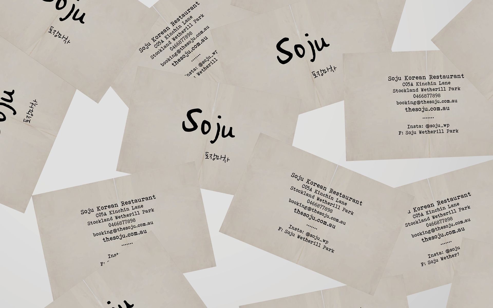 Business cards for Soju, a Korean Restaurant in New South Wales. The design contrasts the bold typography with a neutral background, created by the designers at The End Creative Agency.