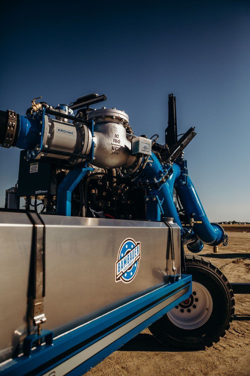 Blue race car engine on a trailer in a desert setting