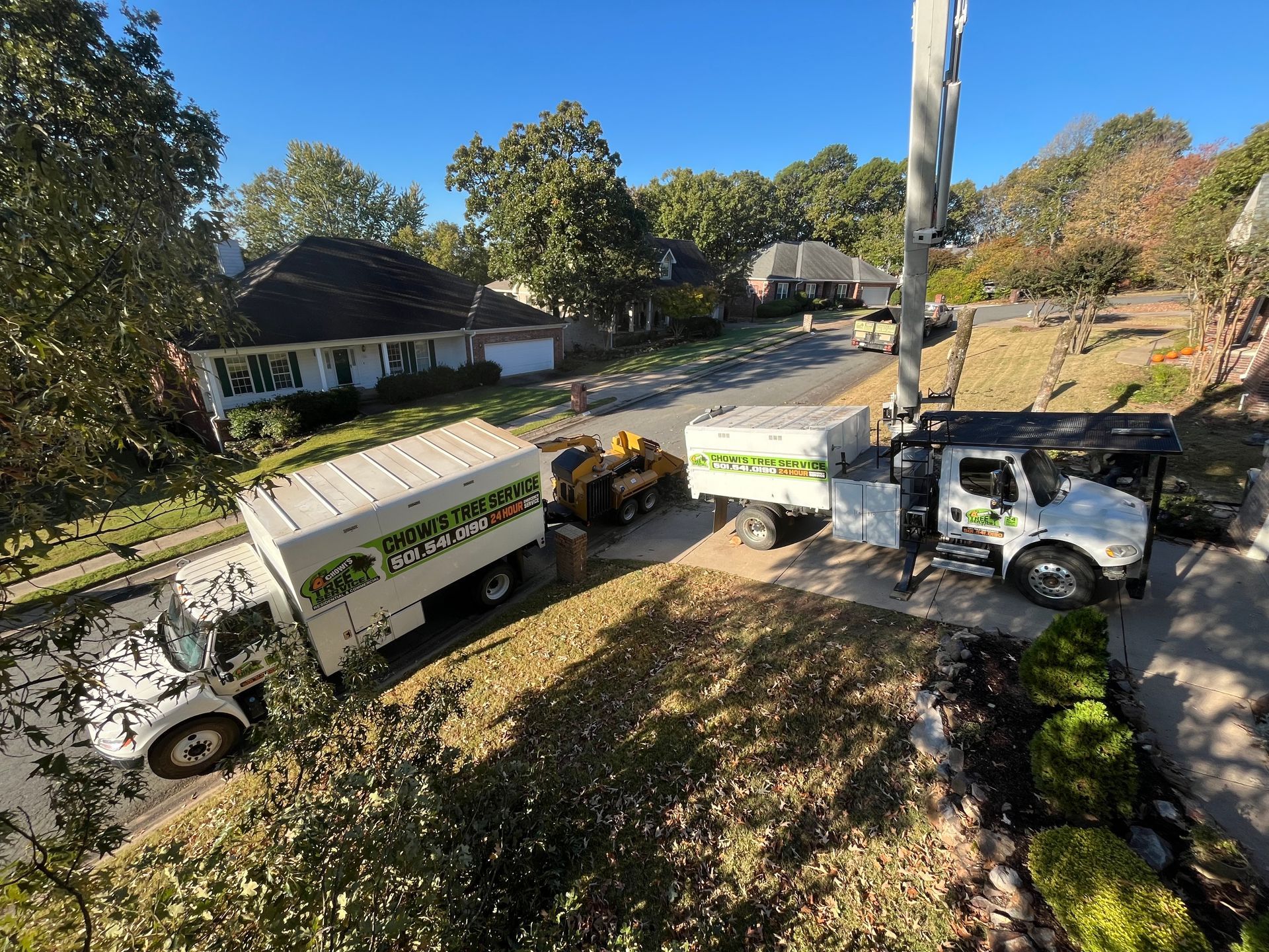 A couple of trucks are parked on the side of the road.