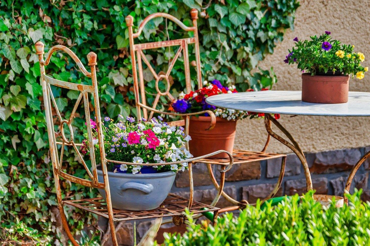 metal outdoor set with flower pots on the chairs' seats