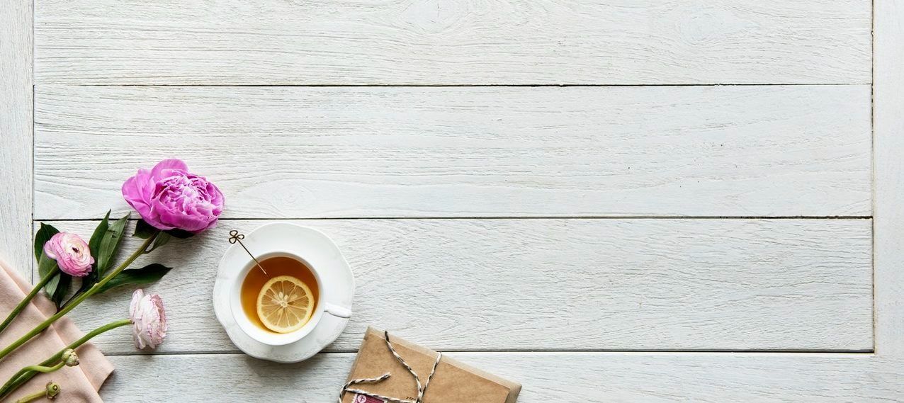 peony, cup of coffee, diary on white-washed wood surface