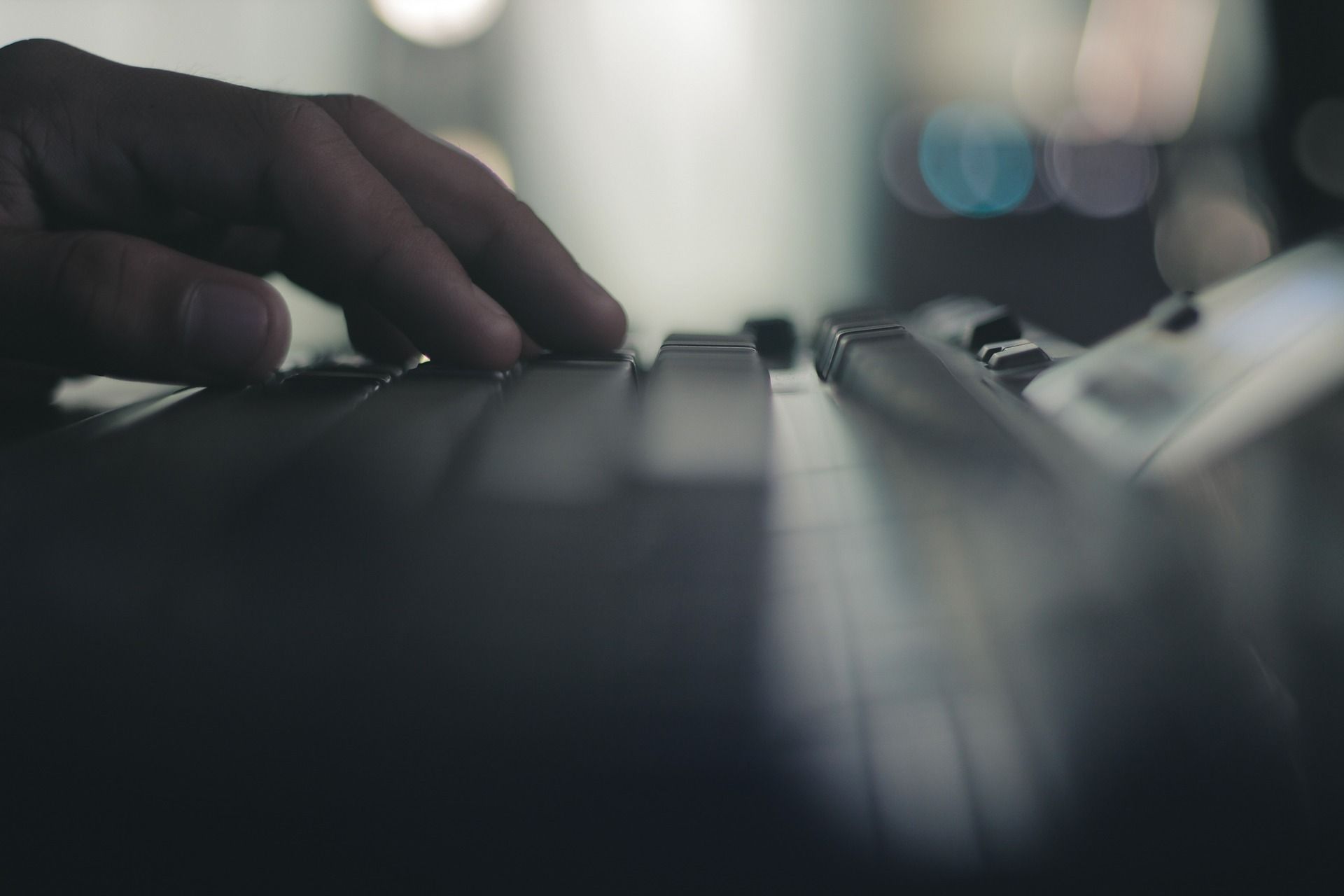 hand on computer keyboard