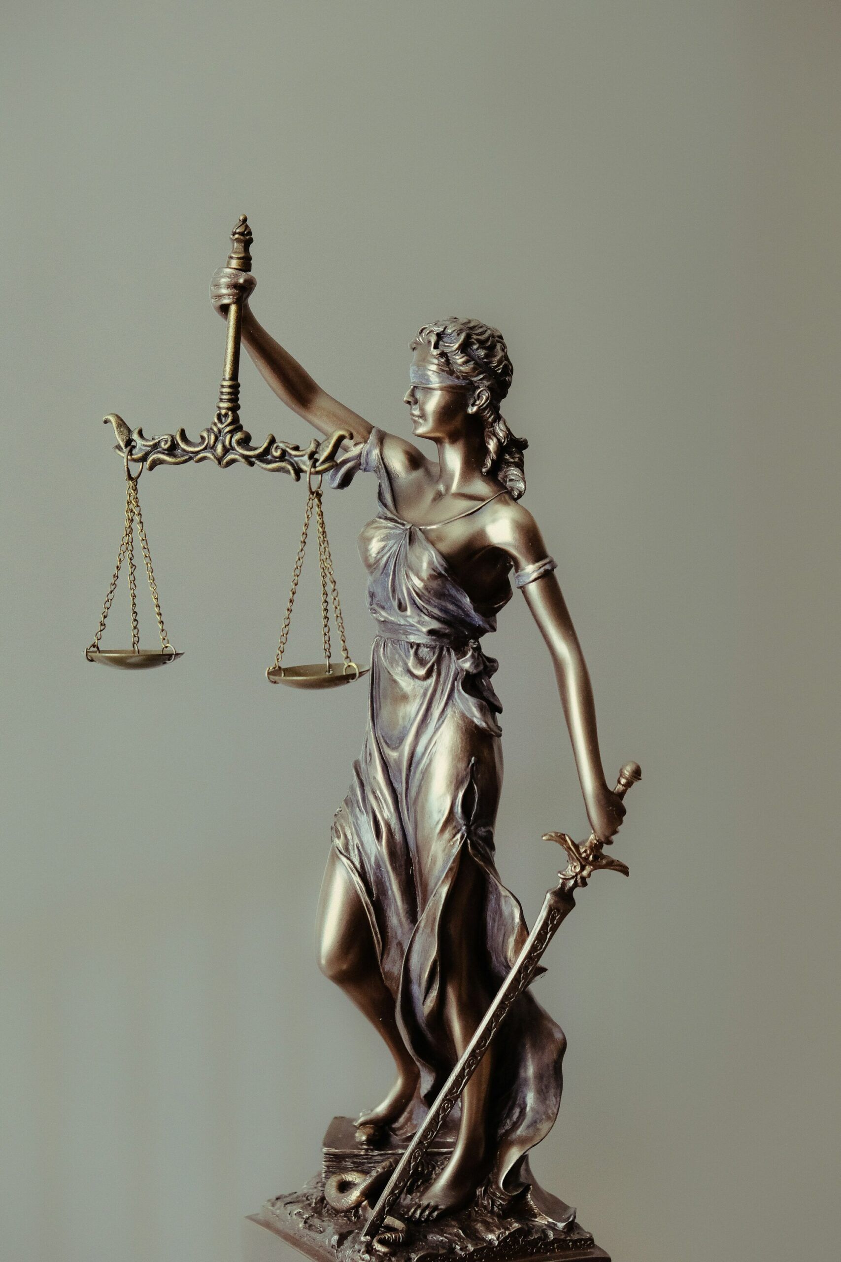 Bronze statue of Lady Justice holding scales and a sword, blindfolded to symbolize impartiality.