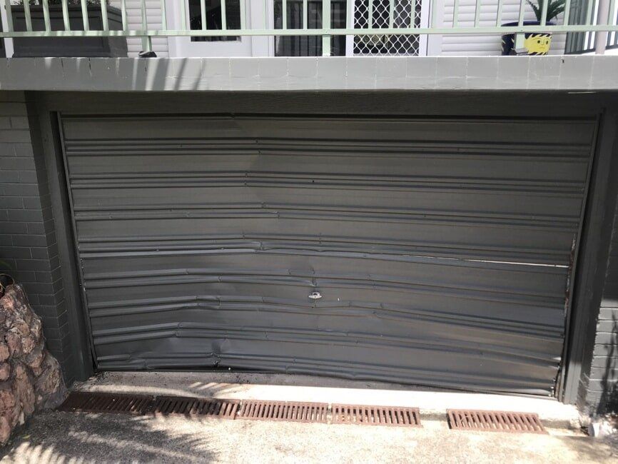Impact Damaged Tilt Door - Before — Garage Doors in Port Macquarie, NSW