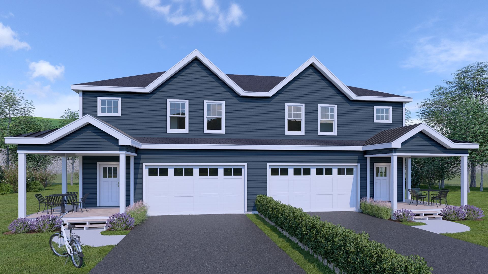 Two-story blue duplex with white trim, porches, garages, and a manicured lawn.