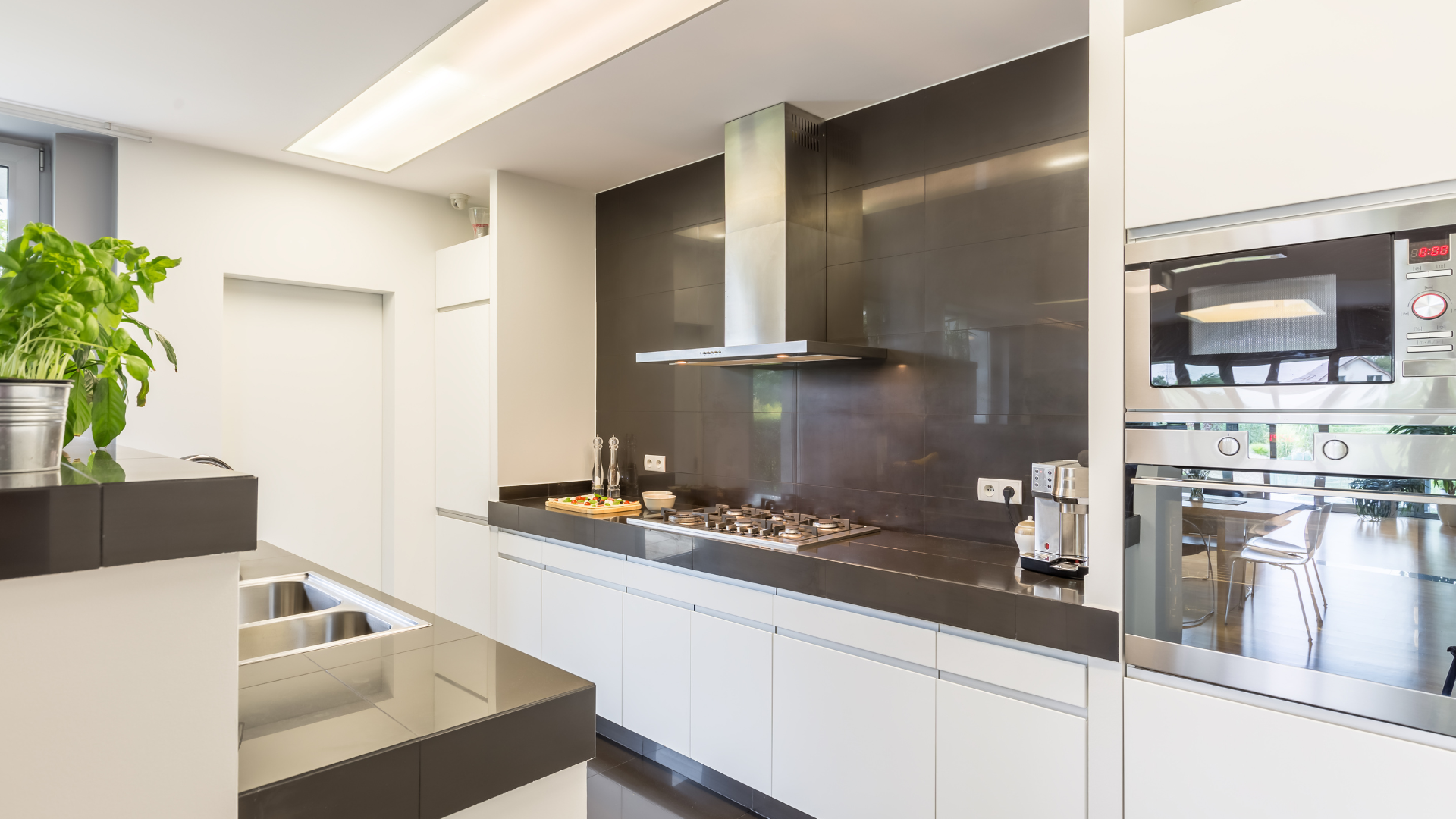 A kitchen with stainless steel appliances and white cabinets.