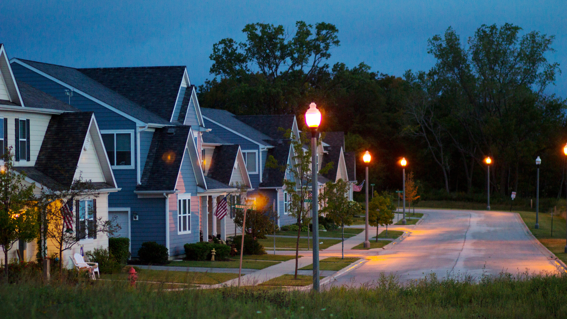A row of houses on a residential street at night