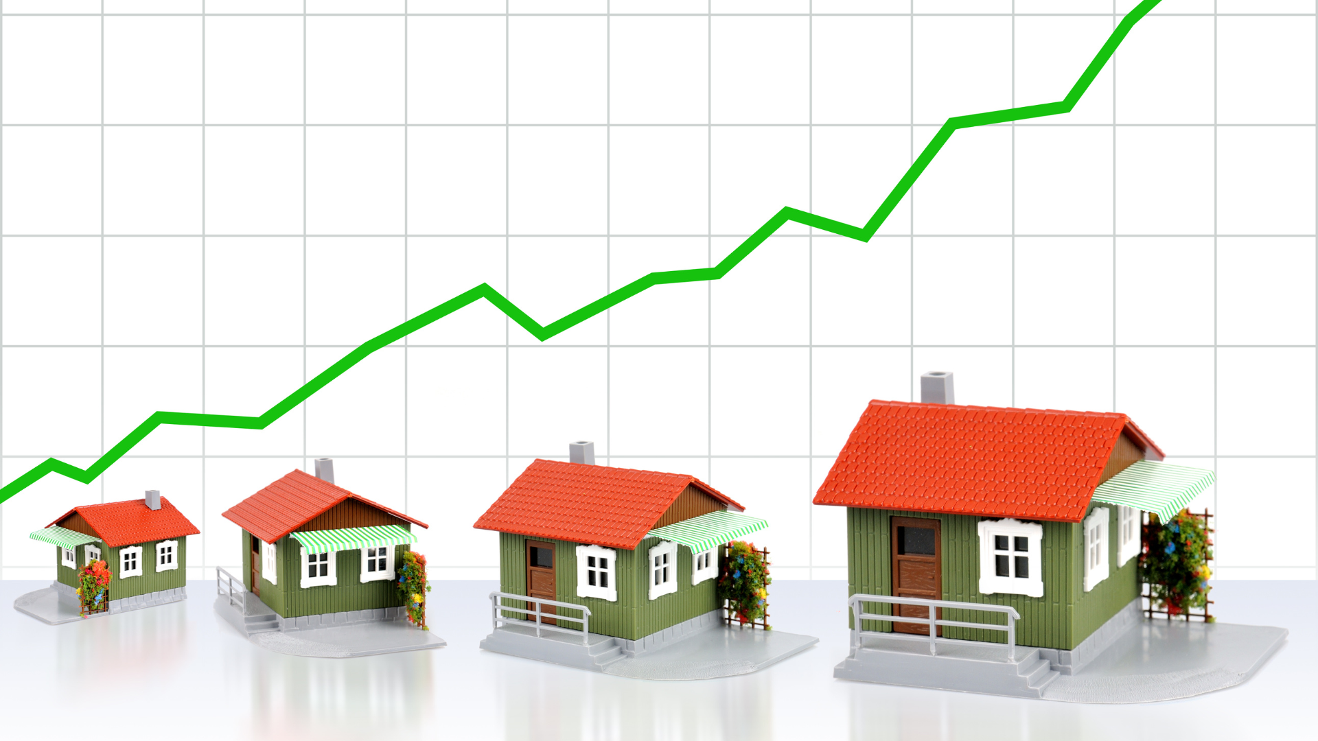A group of houses are sitting in front of a graph showing a rising house price.