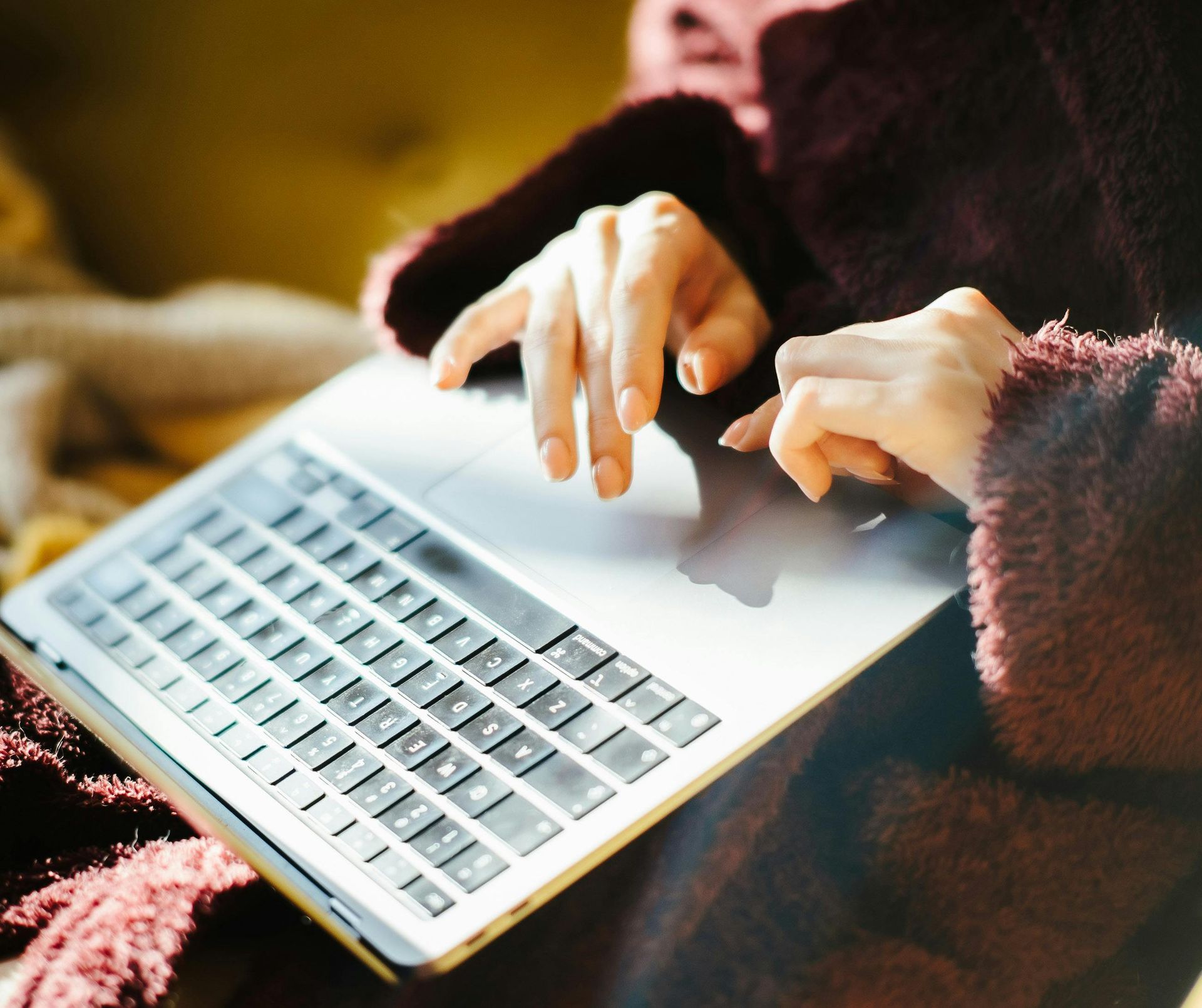 image of woman typing on her computer