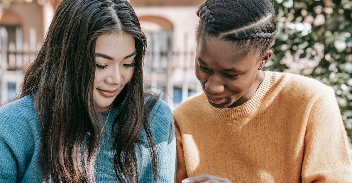 Image of two women looking at social media content on a phone