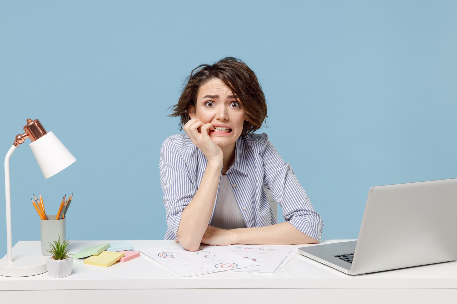 image of a woman holding her head in her hands as she tries to do her own social media marketing