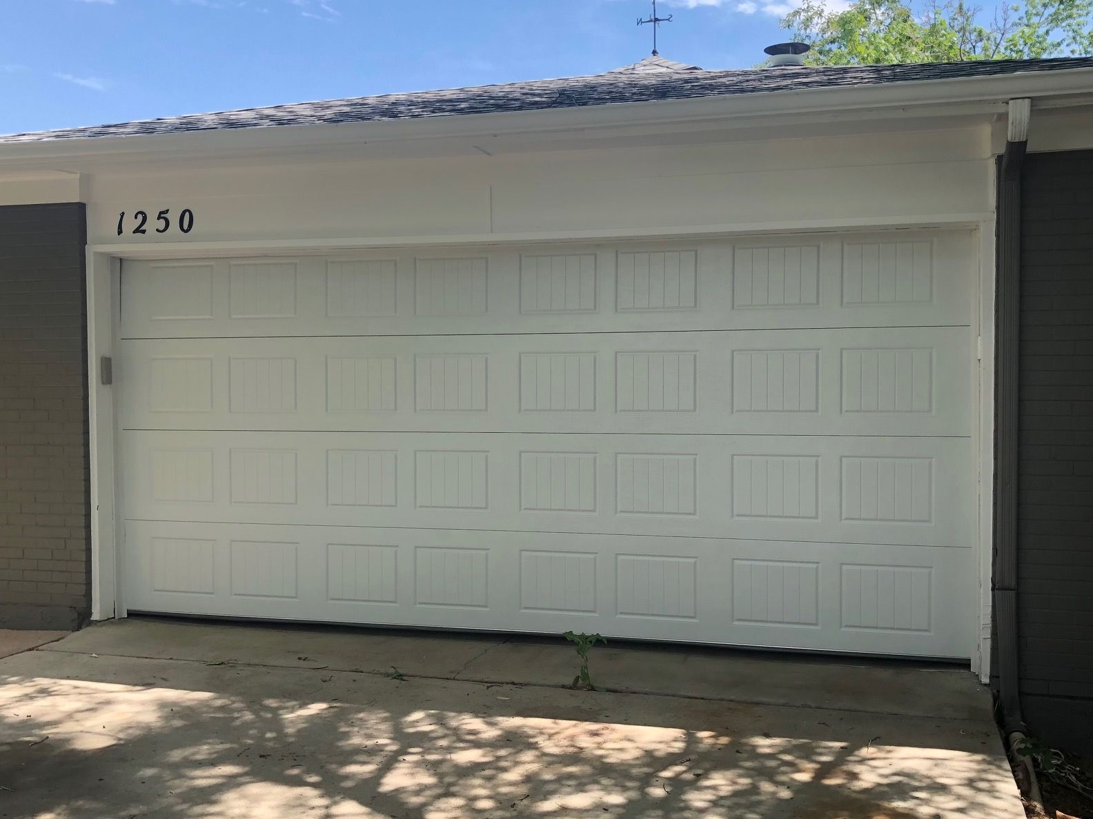 White carriage garage door with house number 