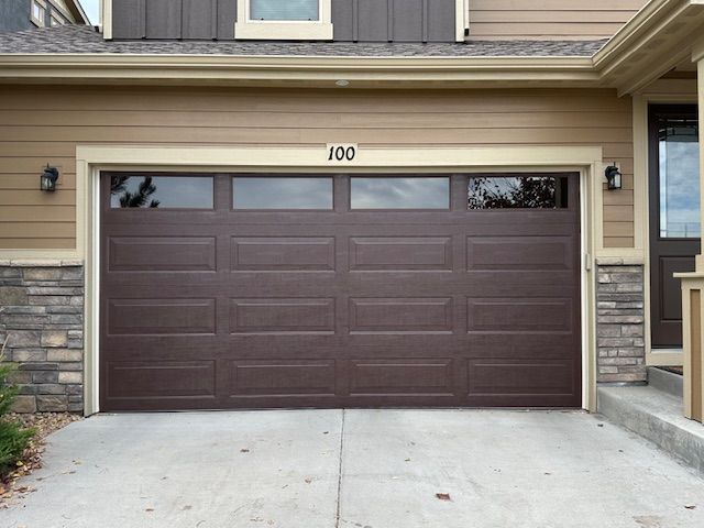 Brown garage door with windows, house number 