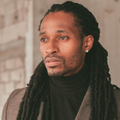 Black male with long braided hair well dressed headshot
