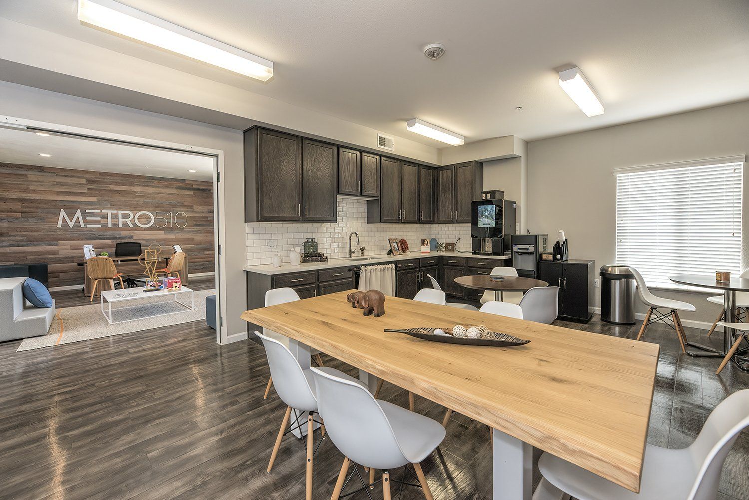 1-BR Apartments In El Cerrito, CA - Metro 510 - Kitchen With Hardwood Style Flooring, High Ceilings, Designer Cabinets, Stainless Steel Appliances, White Tile Backsplash, A Dishwasher, And A Built-In Microwave.