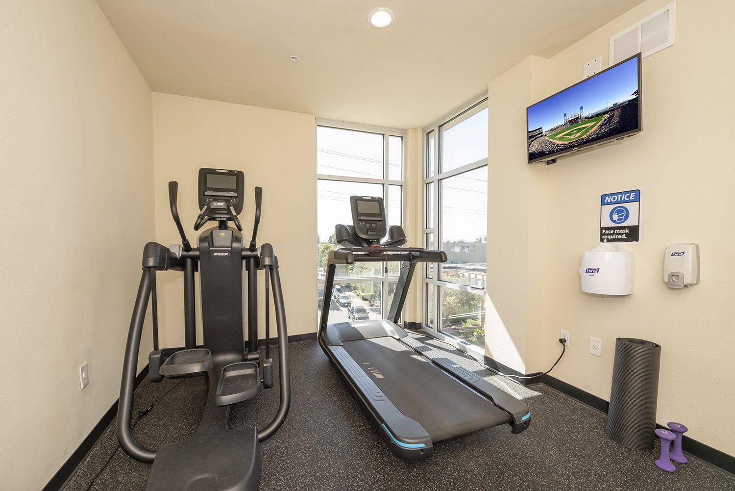 1 BR Apartments in El Cerrito, CA - Metro 510 - A shot fo the fitness center featuring dumbells, workout equipment, and a treadmill