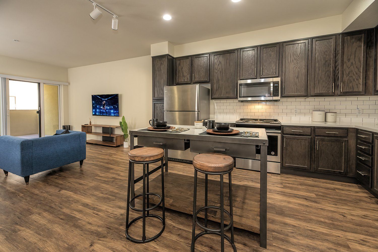 Studio Apartments In El Cerrito, CA - Metro 510 - Open Concept Living Room With High Ceilings, Hardwood Style Flooring, Washer And Dryer, And Access To Kitchen Area.