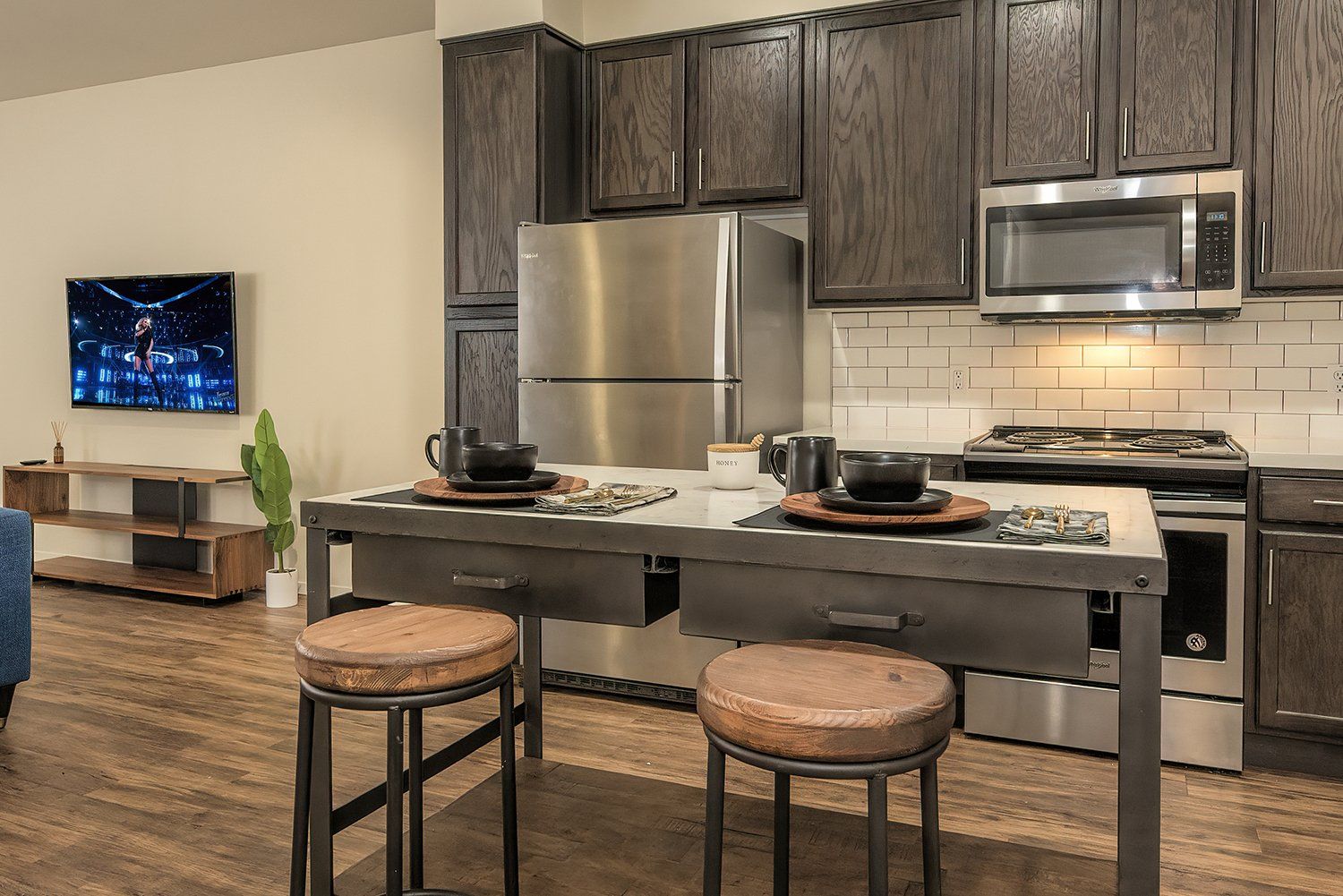 1-BR Apartments In El Cerrito, CA - Metro 510 - Kitchen With Hardwood Style Flooring, High Ceilings, Designer Cabinets, Stainless Steel Appliances, White Tile Backsplash, A Dishwasher, And A Built-In Microwave.