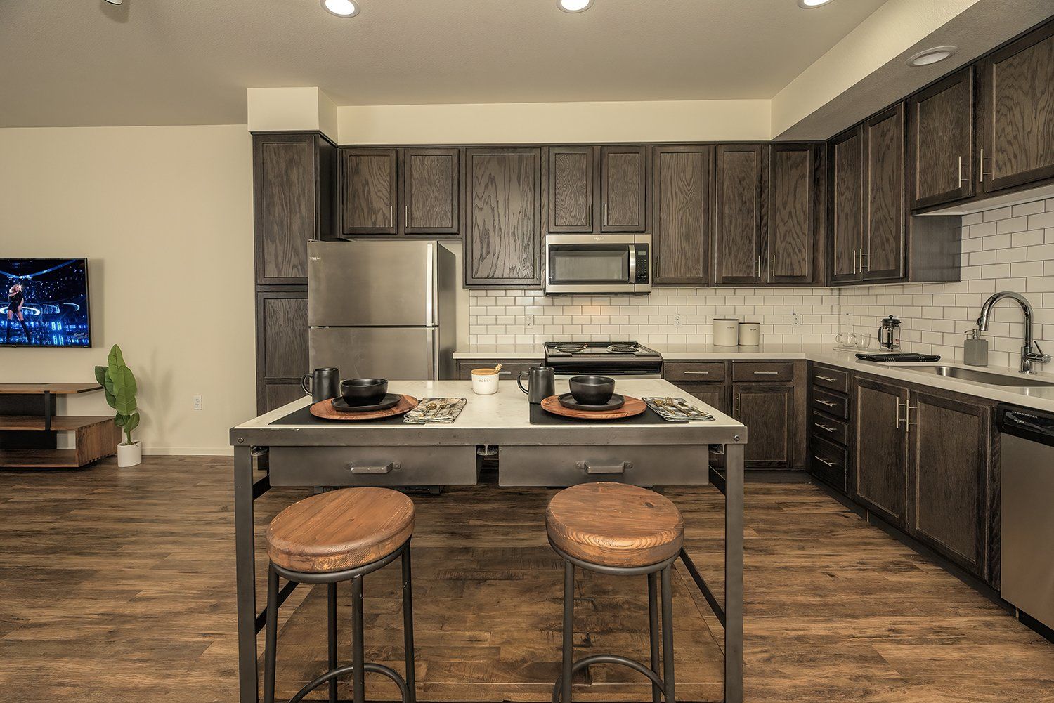 1-BR Apartments In El Cerrito, CA - Metro 510 - Kitchen With Hardwood Style Flooring, High Ceilings, Designer Cabinets, Stainless Steel Appliances, White Tile Backsplash, A Dishwasher, And A Built-In Microwave.