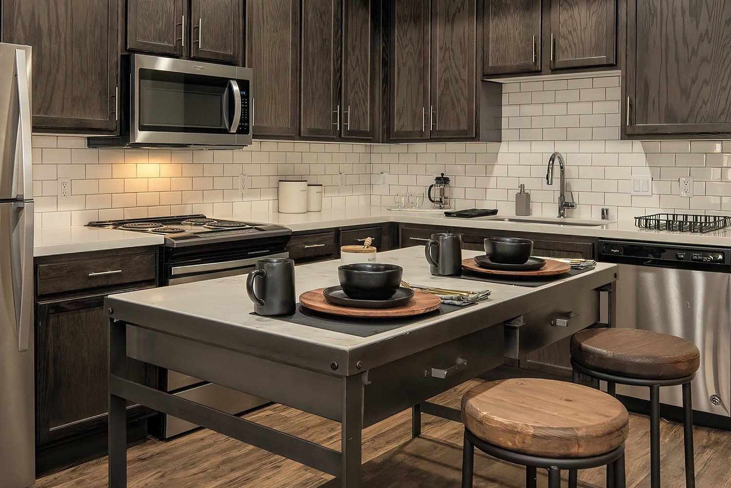 1-BR Apartments In El Cerrito, CA - Metro 510 - Kitchen With Hardwood Style Flooring, High Ceilings, Designer Cabinets, Stainless Steel Appliances, White Tile Backsplash, A Dishwasher, And A Built-In Microwave.