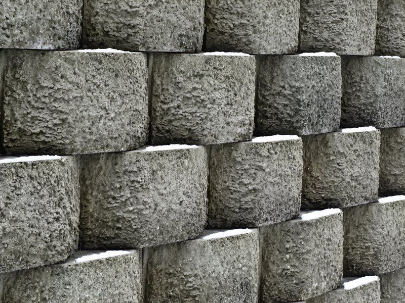 A Close Up Of A Wall Made Of Concrete Blocks Stacked On Top Of Each Other — Tony Eldridge Property Services in Forster, NSW