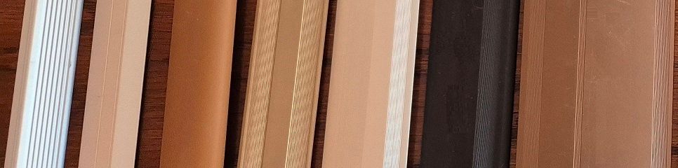 A close up of a row of wooden sticks of different shades.