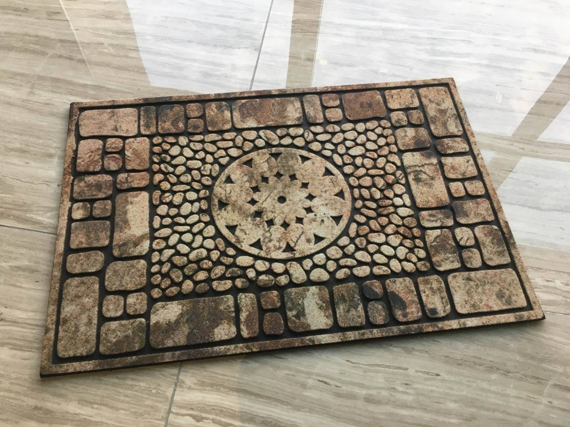 A rug with a stone pattern on it is on a tiled floor