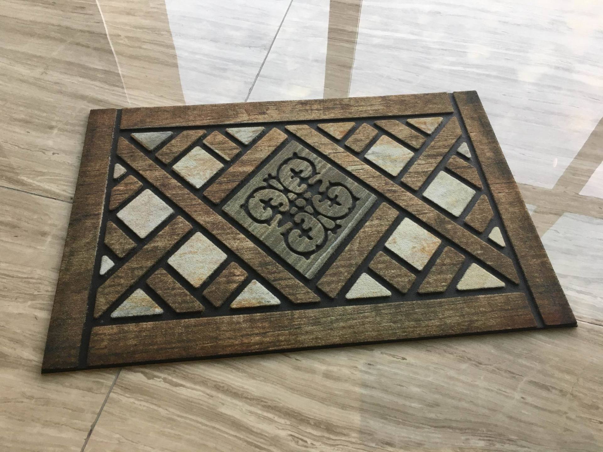 A door mat is sitting on a tiled floor.