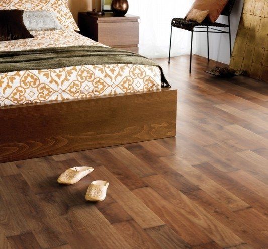 A bedroom with a bed and slippers on the floor