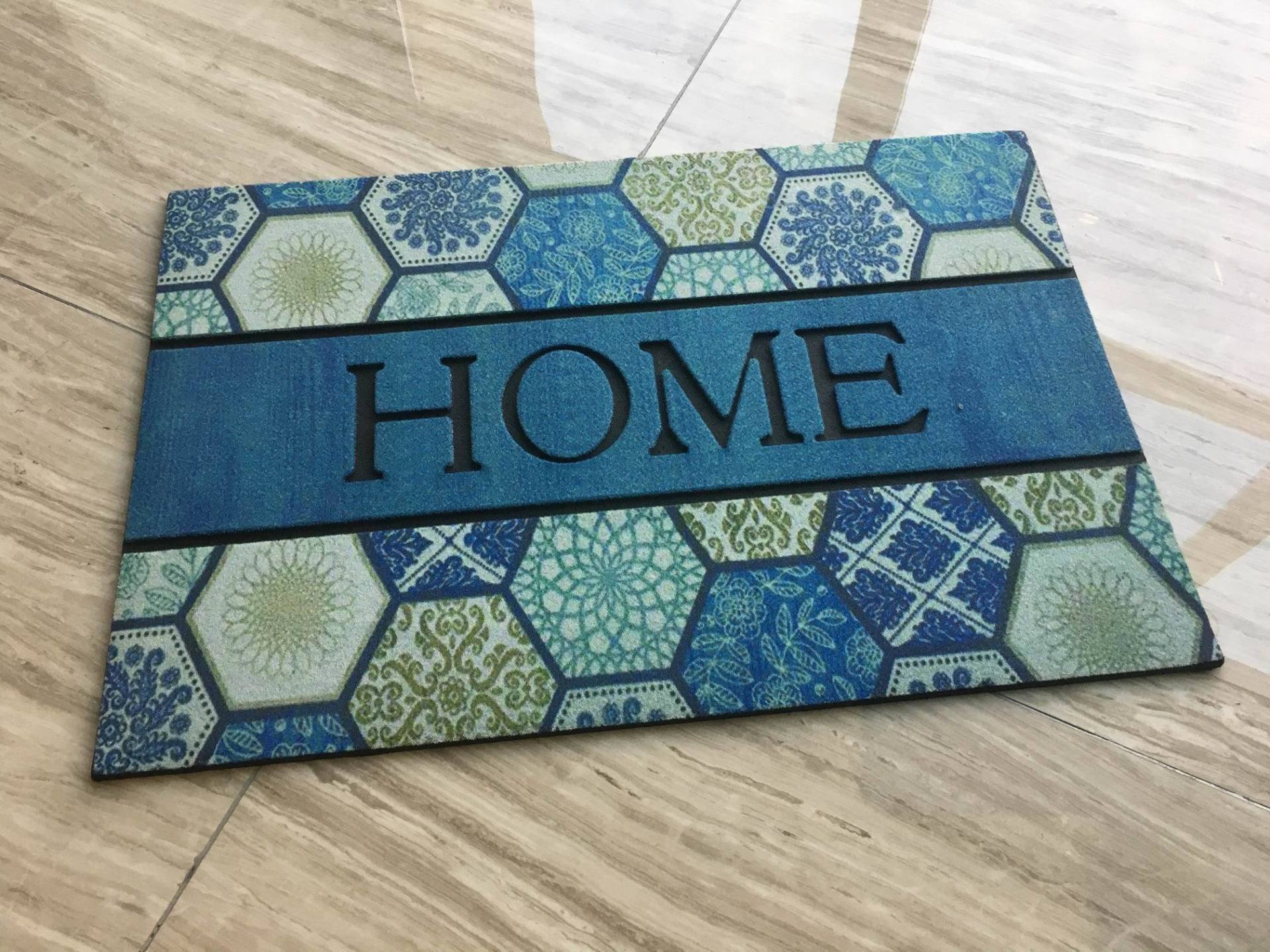 A blue door mat with the word home on it