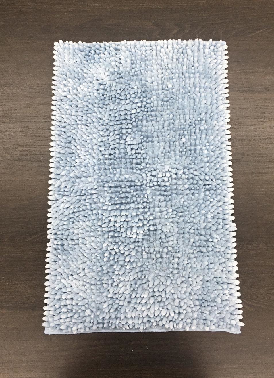 A light blue rug is sitting on a wooden table