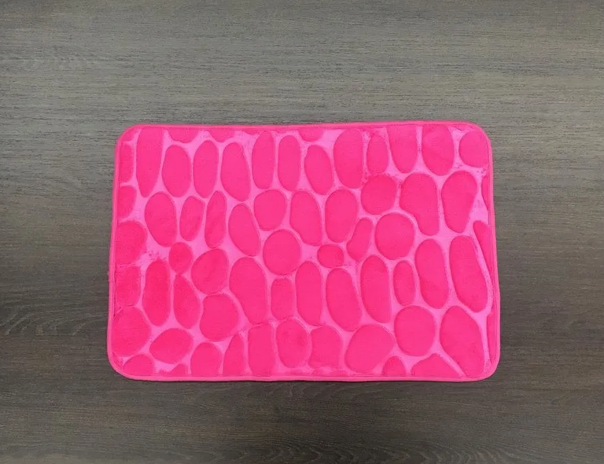 A pink rug with circles on it is on a table