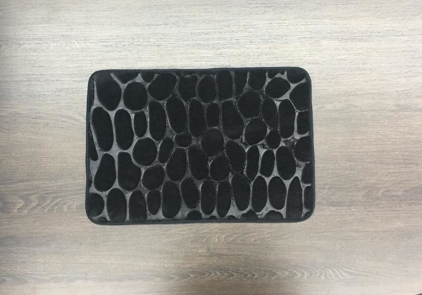 A black and white rug is sitting on a wooden table.