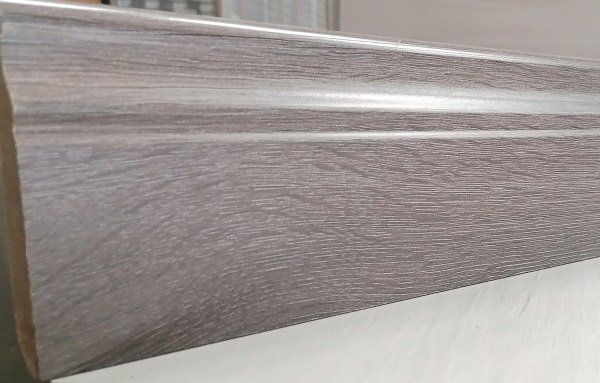 A piece of wood is sitting on top of a white table.