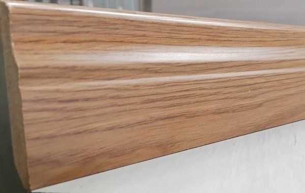 A piece of wood is sitting on top of a white surface.