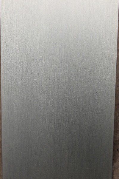 A close up of a piece of stainless steel on a table.