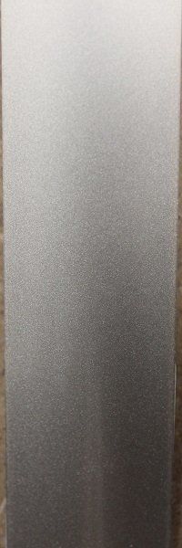 A close up of a stainless steel surface on a wooden table.