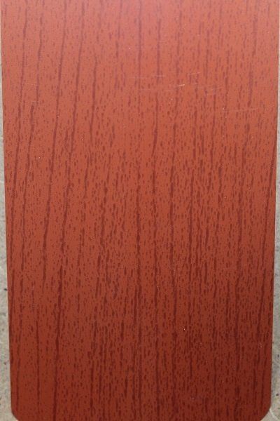 A close up of a piece of red wood on a table.