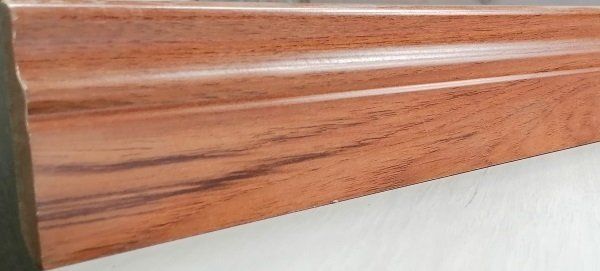 A saw is cutting a piece of wood on a table.