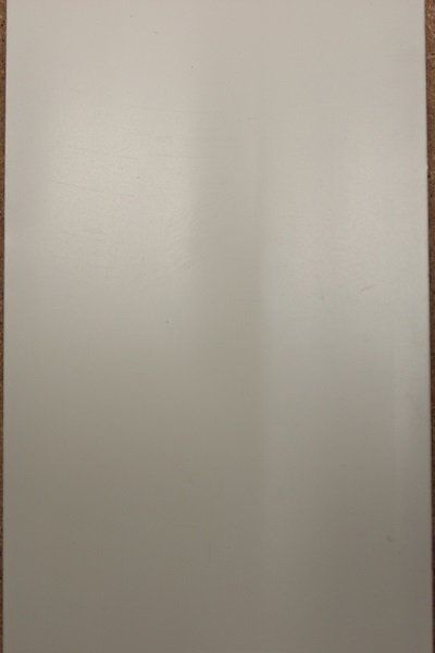A white sheet of paper is sitting on a wooden table.