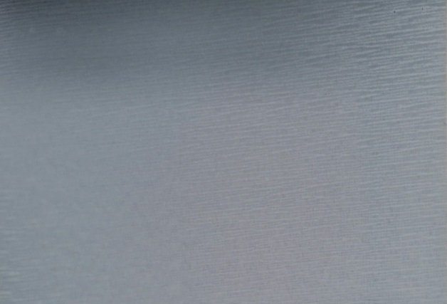 A close up of a piece of paper with a gray background.