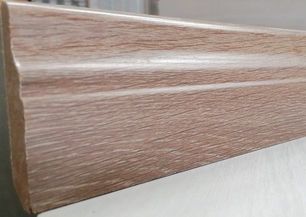 A piece of wood is sitting on top of a white surface.