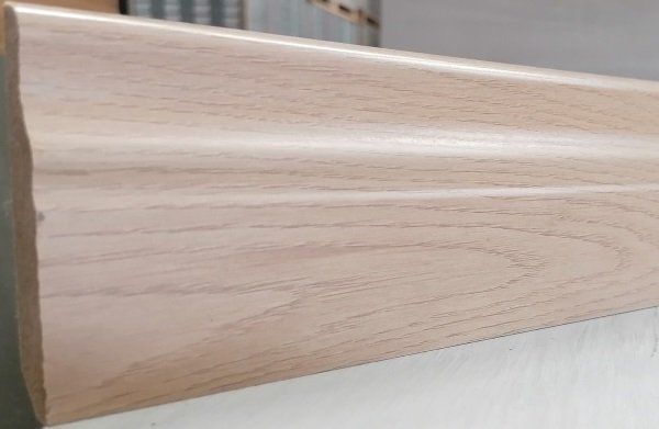 A piece of wood is sitting on a white surface.