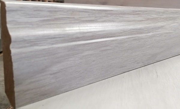 A piece of wood is sitting on top of a white table.