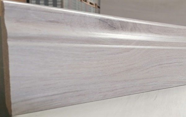 A piece of wood is sitting on top of a white table.