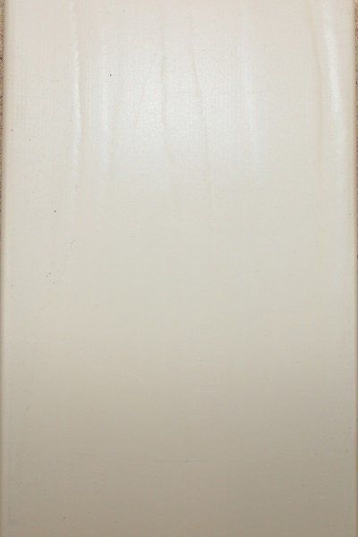 A close up of a piece of white paper on a wall.