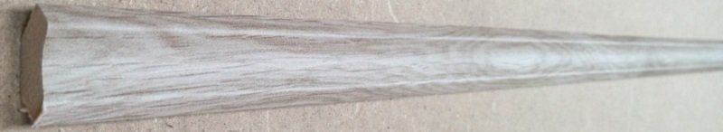 A piece of wood is sitting on top of a wooden table.